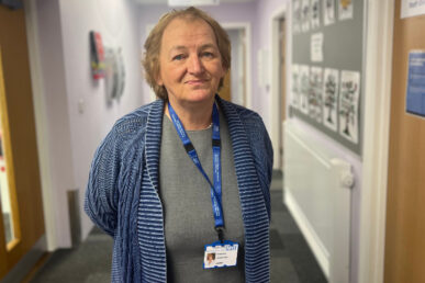 A photo of Carole Melia, our transition lead, stood in a corridor.