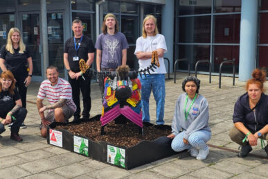 A group of people from the Somerset early intervention in psychosis team stood by the sculpture they made for Taunton Trash Trail