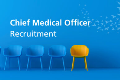 Illustration with a mid blue background and a row of blue chairs ending with a single yellow chair. Above the chairs are the words Chief Medical Officer. Under those words is the single word Recruitment, all in white text. To the right of the text is a murmuration of birds in pale blue to flying in a sweep across the top right corner.