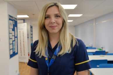 A photo of clinical nurse researcher Ana-Maria Toth standing in the corridor of a hospital ward.