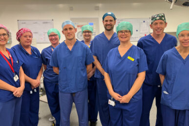A photo of the Minehead Community Hospital theatres team standing in an operating theatre at the hospital.