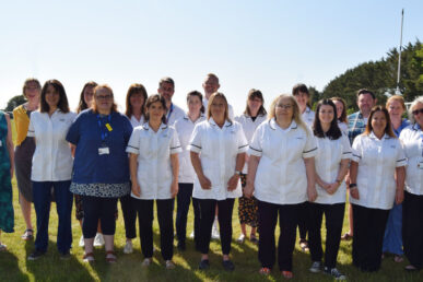 A photograph of colleagues from Somerset's podiatry service standing in a field.