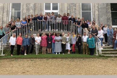 A photo of the Somerset and Dorset community dental team stood outside a large building.