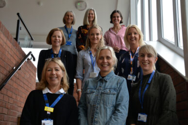 Colleagues from Somerset's Post COVID-19 Assessment Service stood on steps following a meeting.