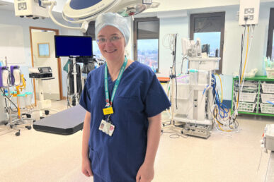 A photo of consultant gynaecological oncologist Miss Jo Morrison stood in an operating theatre.