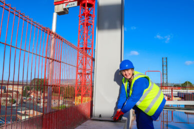 A colleague at Musgrove Park Hospital called Kay Collard is pictured tightening the final of the new surgical centre roof in a ceremony.