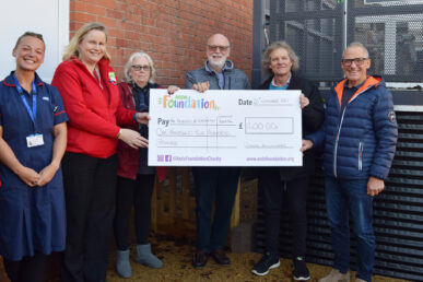 A photo of colleagues from Wincanton Hospital, Asda and the Friends of Wincanton Hospital with a large cheque stood next to the hospital's new lift.